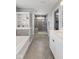 Bathroom featuring a glass enclosed shower, bathtub, and vanity with storage and lighting at 2447 Stonehaven Dr, Avon, IN 46123
