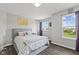 Bedroom with light gray walls, hardwood flooring, and a picturesque window view at 2447 Stonehaven Dr, Avon, IN 46123