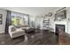 Living room with a fireplace, dark hardwood floors and a view to the outside patio at 2447 Stonehaven Dr, Avon, IN 46123