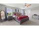 Spacious main bedroom with windows, ceiling fan, carpet flooring, and walk-in closet access at 2447 Stonehaven Dr, Avon, IN 46123