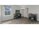 Home office featuring dark wood floors, natural light, and simple black furnishings at 2447 Stonehaven Dr, Avon, IN 46123