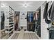 Spacious walk-in closet with custom shelving, ample storage, and a mirrored door at 2447 Stonehaven Dr, Avon, IN 46123