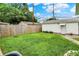 A spacious backyard with a well-maintained lawn, a detached garage, and privacy fencing, ideal for outdoor activities and gatherings at 2538 Sickle Rd, Indianapolis, IN 46219