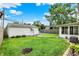 This backyard features a lush green lawn, a detached garage, and a cozy patio area, perfect for relaxing and entertaining at 2538 Sickle Rd, Indianapolis, IN 46219