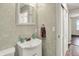 This bathroom includes a sink, a vanity, a sliding door closet, and a patterned wall at 2538 Sickle Rd, Indianapolis, IN 46219
