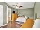 Bedroom featuring hardwood floors, ceiling fan, neutral walls, and dresser at 2538 Sickle Rd, Indianapolis, IN 46219