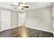 This bedroom includes neutral walls, wood floors, a ceiling fan, and a closet at 2538 Sickle Rd, Indianapolis, IN 46219