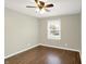 Cozy bedroom featuring hardwood floors, a ceiling fan, and a bright window at 2538 Sickle Rd, Indianapolis, IN 46219