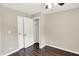 This bedroom offers wood floors, neutral walls, a ceiling fan, and a closet with doors at 2538 Sickle Rd, Indianapolis, IN 46219