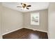 This bedroom features neutral walls, wood floors, a ceiling fan, and a window with blinds at 2538 Sickle Rd, Indianapolis, IN 46219