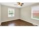 This bedroom boasts neutral walls, wood floors, two windows, and natural light at 2538 Sickle Rd, Indianapolis, IN 46219