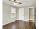 Bright bedroom with hardwood floors, a window with blinds, and two entryways at 2538 Sickle Rd, Indianapolis, IN 46219