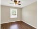 Bedroom featuring neutral walls, laminate floors, window, and ceiling fan at 2538 Sickle Rd, Indianapolis, IN 46219