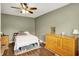 Cozy bedroom featuring neutral walls, laminate floors, and ceiling fan at 2538 Sickle Rd, Indianapolis, IN 46219