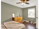 Bedroom featuring hardwood floors, neutral walls, ceiling fan, and window at 2538 Sickle Rd, Indianapolis, IN 46219