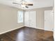 This bedroom features neutral walls, wood floors, a window, and a closet at 2538 Sickle Rd, Indianapolis, IN 46219