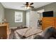 Bedroom with window and doorway featuring hardwood floors, neutral walls, and ceiling fan at 2538 Sickle Rd, Indianapolis, IN 46219