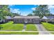Charming single-story home with a brick facade, a well-manicured lawn, and a concrete driveway, offering a welcoming curb appeal at 2538 Sickle Rd, Indianapolis, IN 46219