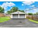 A two-car garage with gray doors, siding, and a paved driveway, providing plenty of parking and storage space at 2538 Sickle Rd, Indianapolis, IN 46219