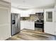 Updated kitchen with stainless steel appliances, white cabinetry, and durable flooring at 2538 Sickle Rd, Indianapolis, IN 46219