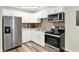 Modern kitchen boasts white cabinets, stainless steel appliances, and mosaic backsplash at 2538 Sickle Rd, Indianapolis, IN 46219