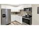 Well-lit kitchen featuring stainless steel appliances, white cabinets, and a stylish backsplash at 2538 Sickle Rd, Indianapolis, IN 46219