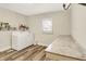 Well-lit laundry room featuring a washer, dryer, counter space, and storage at 2538 Sickle Rd, Indianapolis, IN 46219