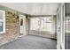 Spacious sunroom featuring brick walls, an exterior door, and large windows at 2538 Sickle Rd, Indianapolis, IN 46219