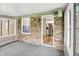 Bright sunroom with brick walls, view of kitchen and windows overlooking the yard at 2538 Sickle Rd, Indianapolis, IN 46219