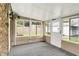 Well-lit sunroom featuring brick accent walls, large windows, and an exterior door at 2538 Sickle Rd, Indianapolis, IN 46219