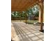 View of a backyard with a shed and concrete patio underneath a wooden pergola, surrounded by trees at 2936 Guilford Ave, Indianapolis, IN 46205