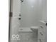 Modern bathroom with tiled shower, white vanity, and toilet at 2936 Guilford Ave, Indianapolis, IN 46205
