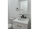 Clean bathroom with white vanity, black fixtures, and modern design at 2936 Guilford Ave, Indianapolis, IN 46205