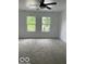 Bedroom with neutral carpet, ceiling fan, and two windows at 2936 Guilford Ave, Indianapolis, IN 46205