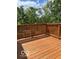 Spacious deck with a wooden railing, offering an inviting outdoor space surrounded by lush trees at 2936 Guilford Ave, Indianapolis, IN 46205