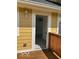 Exterior view of a house with a wooden deck showcasing a doorway leading to an interior room at 2936 Guilford Ave, Indianapolis, IN 46205