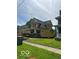 Yellow two-story home with inviting porch and green lawn at 2936 Guilford Ave, Indianapolis, IN 46205