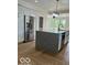 Open-concept kitchen with stainless steel appliances and stone-topped island at 2936 Guilford Ave, Indianapolis, IN 46205
