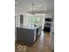 Bright kitchen with gray granite island, stainless steel appliances, and herringbone wood floors at 2936 Guilford Ave, Indianapolis, IN 46205