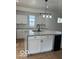 Well-lit kitchen with gray granite counters, white cabinets, and stainless wine cooler at 2936 Guilford Ave, Indianapolis, IN 46205