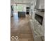Open concept living area with herringbone floors, fireplace, and kitchen with granite island at 2936 Guilford Ave, Indianapolis, IN 46205