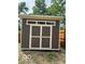 A modern shed painted with a neutral color palette, white trim, and a stylish transom window at 2936 Guilford Ave, Indianapolis, IN 46205