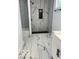 Marble tiled shower with a tiled shower niche and black shower head at 2936 Guilford Ave, Indianapolis, IN 46205