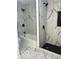 Marble tiled shower with a tiled shower niche, black shower head and tub at 2936 Guilford Ave, Indianapolis, IN 46205