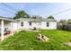 A spacious backyard featuring a grass lawn, firepit, and a quaint white home at 315 Schoolhouse Rd, Franklin, IN 46131