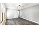 Bright and airy bedroom with modern flooring, a ceiling fan, and ample natural light from the windows at 315 Schoolhouse Rd, Franklin, IN 46131