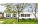 Charming single-story home with a stone facade and a welcoming front porch, surrounded by lush green landscaping at 315 Schoolhouse Rd, Franklin, IN 46131