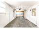 A well-lit, empty garage featuring a concrete floor and white walls at 315 Schoolhouse Rd, Franklin, IN 46131