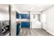 Bright kitchen featuring blue cabinets, modern appliances, and laundry area, perfect for everyday living at 315 Schoolhouse Rd, Franklin, IN 46131