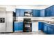 Functional kitchen featuring blue cabinets, stainless steel refrigerator, and modern appliances for easy meal preparation at 315 Schoolhouse Rd, Franklin, IN 46131
